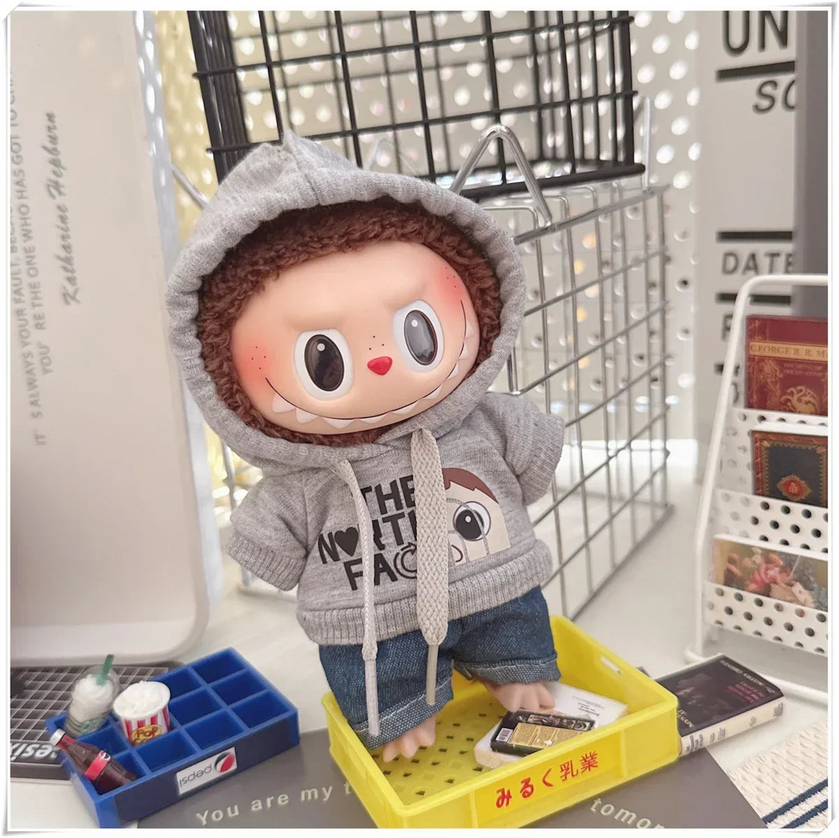 Plush toy with a gray hoodie and brown hair in a casual setting