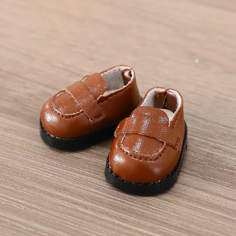 Pair of brown leather shoes on a wooden surface