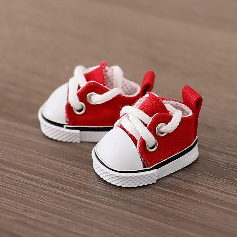 Red and white baby sneakers on a wooden surface