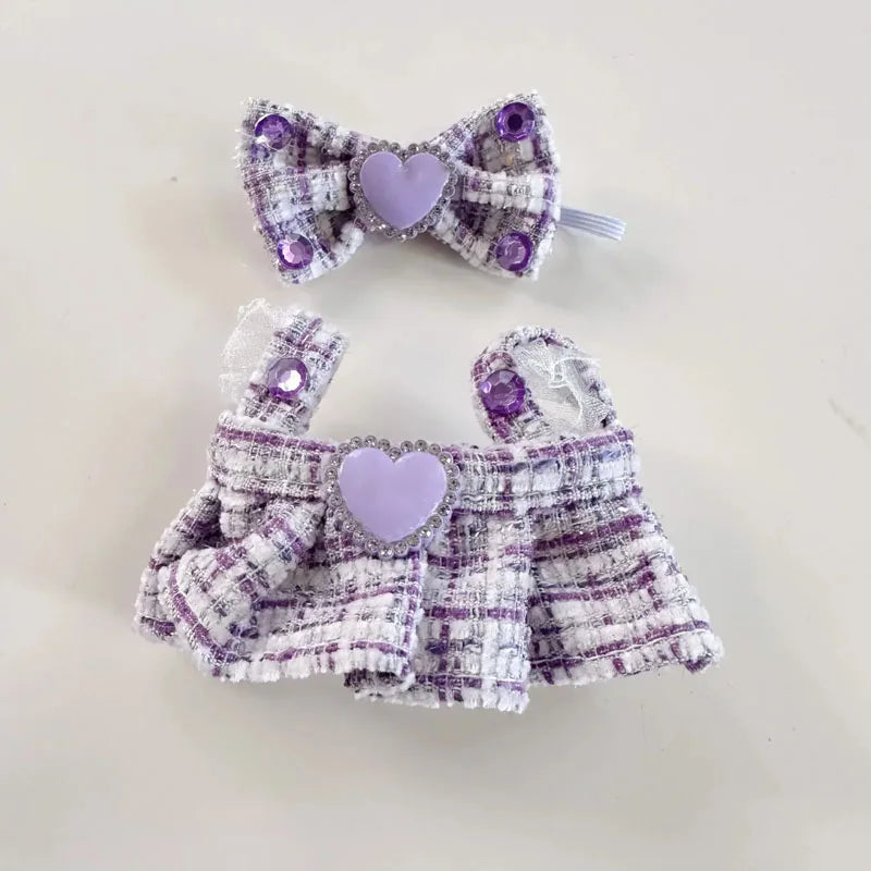 Purple and white checkered pet dress with matching bow on a light background