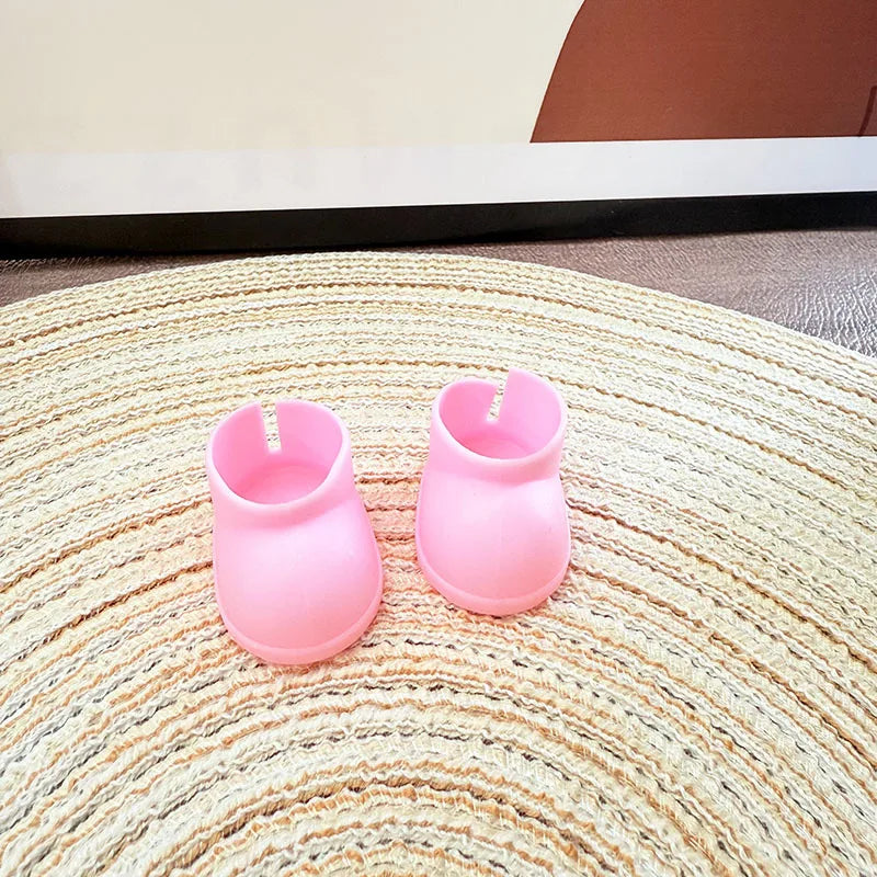 Two pink silicone cupcake molds on a textured surface