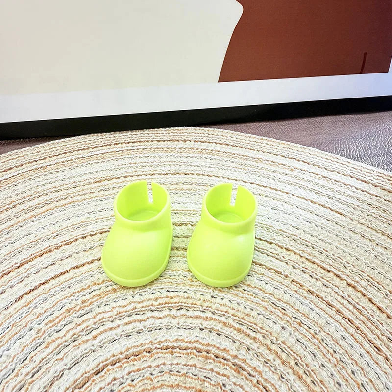 Two neon green shoe trees on a textured surface