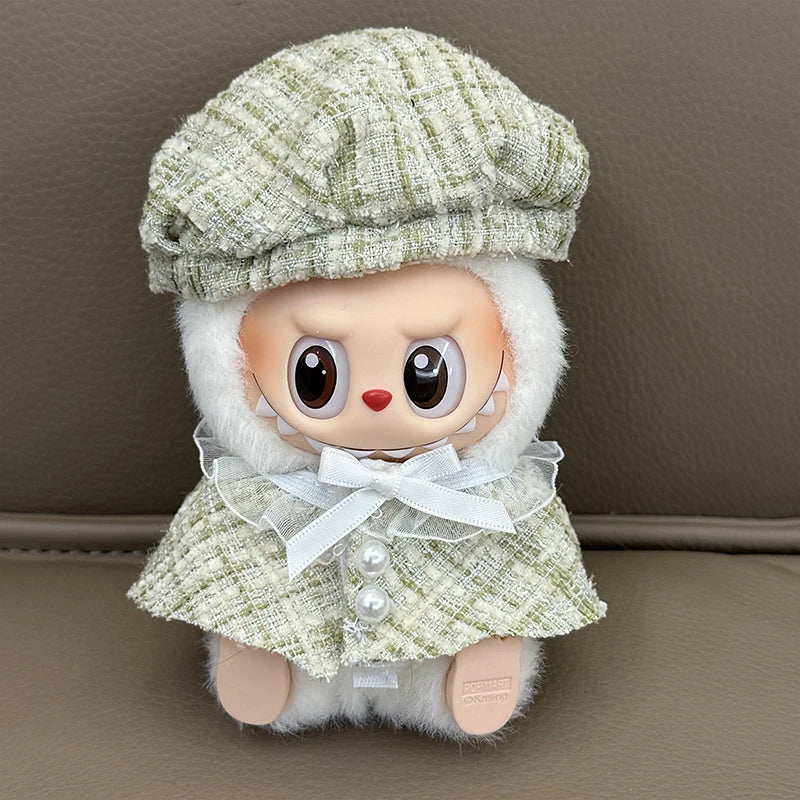Stuffed toy with a green hat and dress on a brown surface