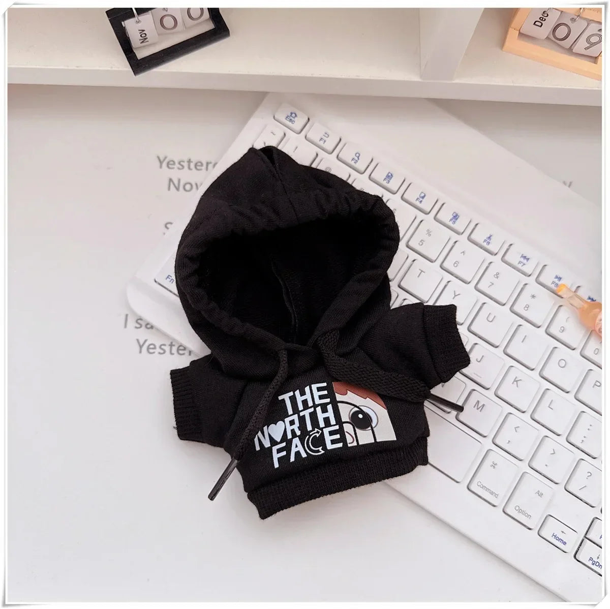 Black hoodie with 'The North Face' logo on a keyboard