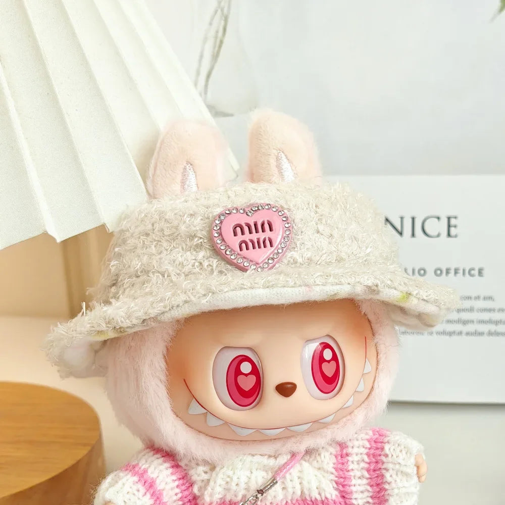 Plush toy with a heart-shaped badge and pink and white striped outfit on a light background