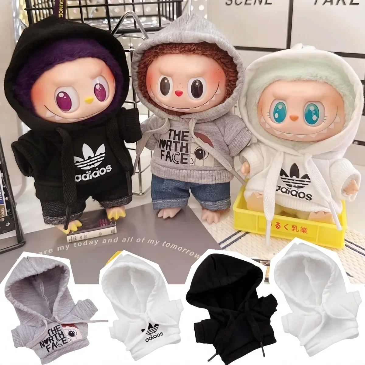 Three cartoon characters wearing hoodies with visible brand logos on a surface.