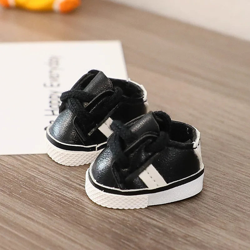 Black high-top sneakers with white soles on a wooden surface