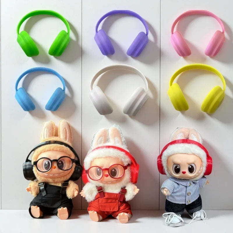 Colorful toy headphones with corresponding plush toys on a white background