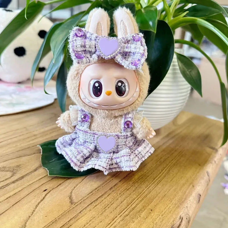 Toy figure with a bunny costume and purple accents on a wooden surface with a plant in the background