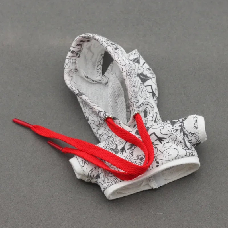 Pair of white socks with black patterns and red shoelaces on a gray background