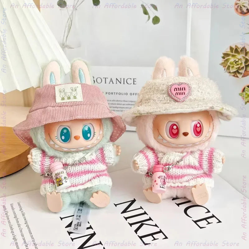 Two cute plush toys with hats and sweaters on a surface with visible text.