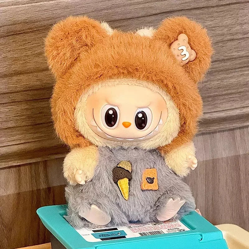Plush toy with bear ears and a gray body on a wooden surface