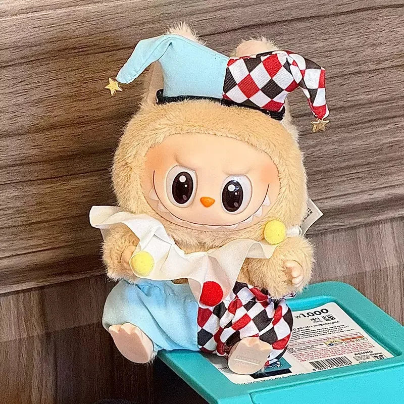 Plush toy with checkered hat and outfit on a teal box against a wooden background