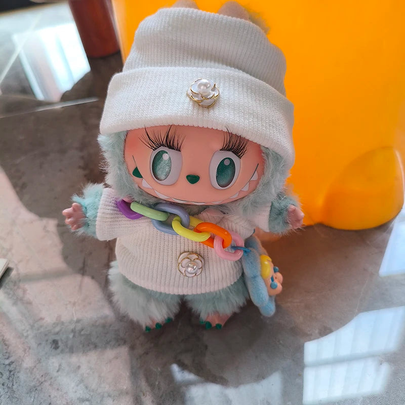 Toy figure with a white hat and colorful necklace on a reflective surface
