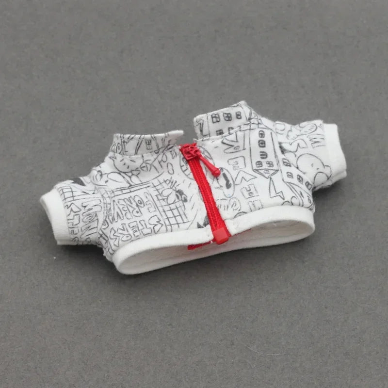 Small white garment with black patterns and a red zipper on a gray background