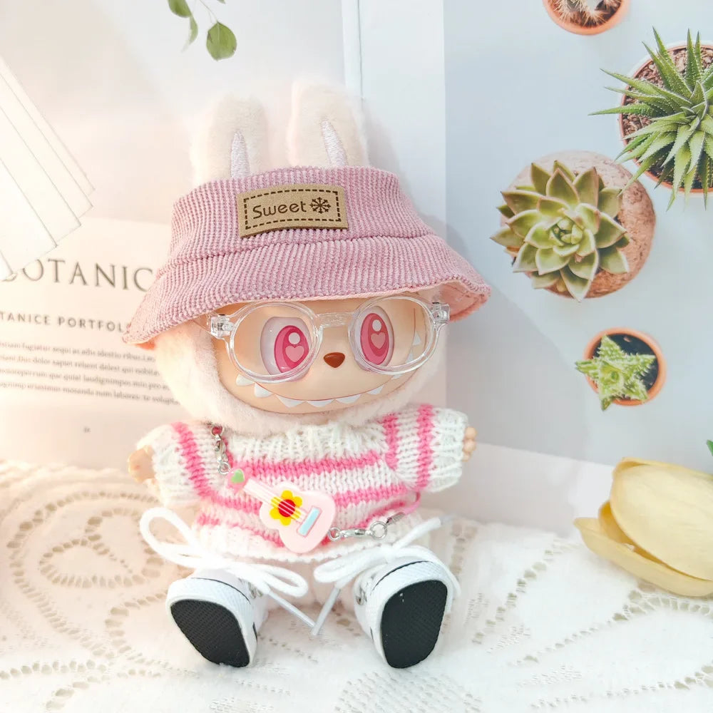 Toy figure wearing a pink hat and sweater with a white background