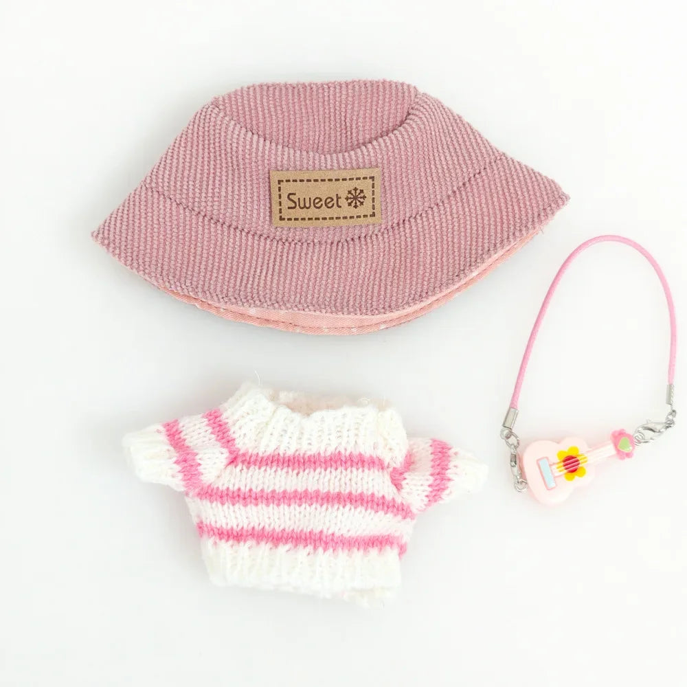 Pink and white striped baby hat, mittens, and keychain set on a light gray background