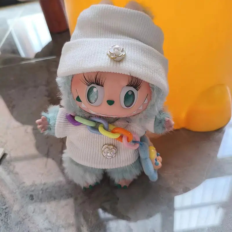 Toy figure with a white hat and colorful scarf on a surface