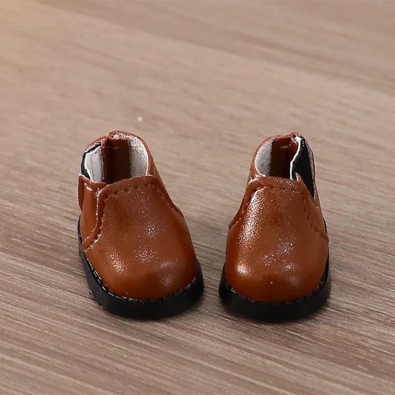 Pair of brown shoes on a wooden surface