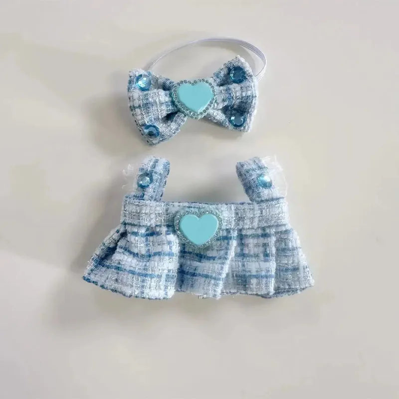 Baby outfit with blue plaid pattern and heart details on a light background