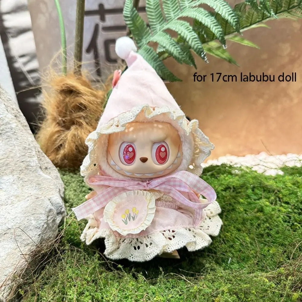 17cm labubu doll with a pink outfit and white hat on a grassy background
