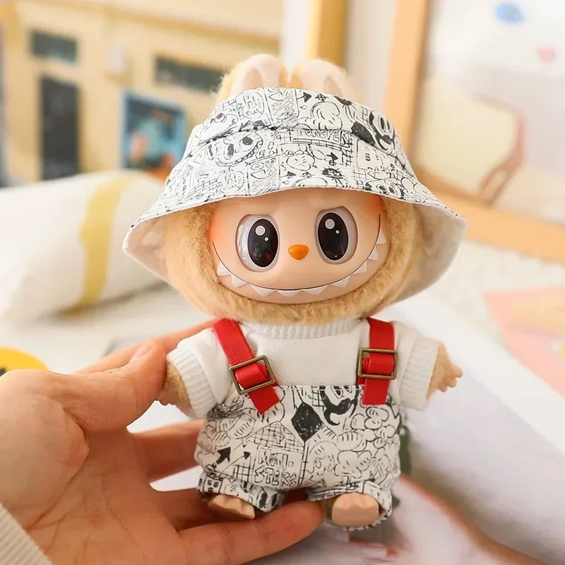 Toy figure with a patterned hat and overalls held in a hand