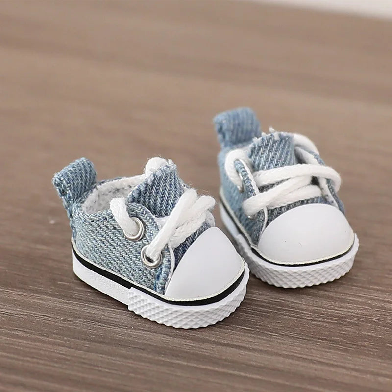 Pair of blue and white baby sneakers on a wooden surface