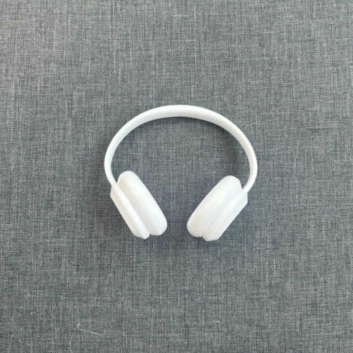 White headphones on a gray textured background