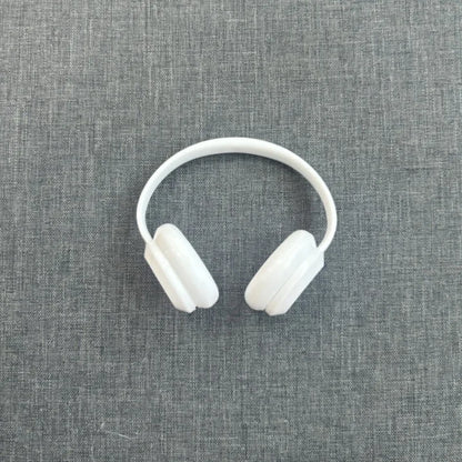 White headphones on a gray textured background