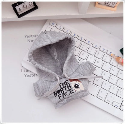 Gray baby hoodie with 'The North Face' logo on a keyboard