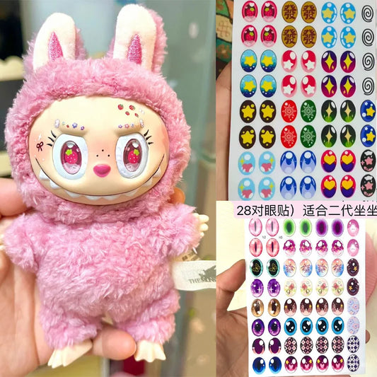 Pink plush toy with bunny ears and a sheet of colorful stickers.