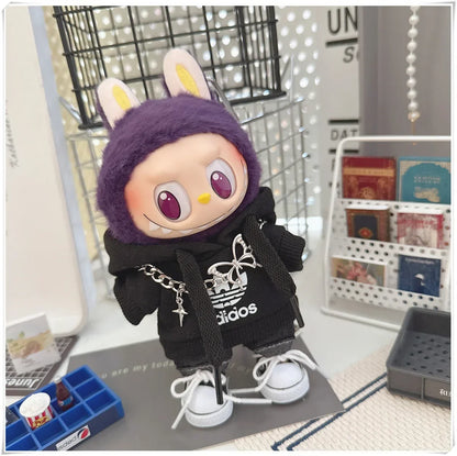 Plush toy with animal ears and a black outfit on a table with various items.