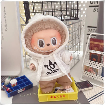 Toy figure wearing an Adidas hoodie in a room setting