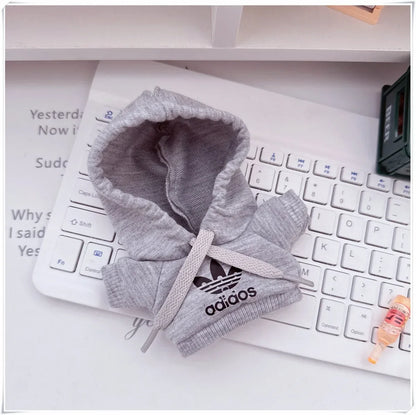 Gray hoodie with Adidas logo on a white keyboard
