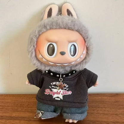 Toy figure with rabbit ears wearing a dark hoodie and pants on a wooden surface.