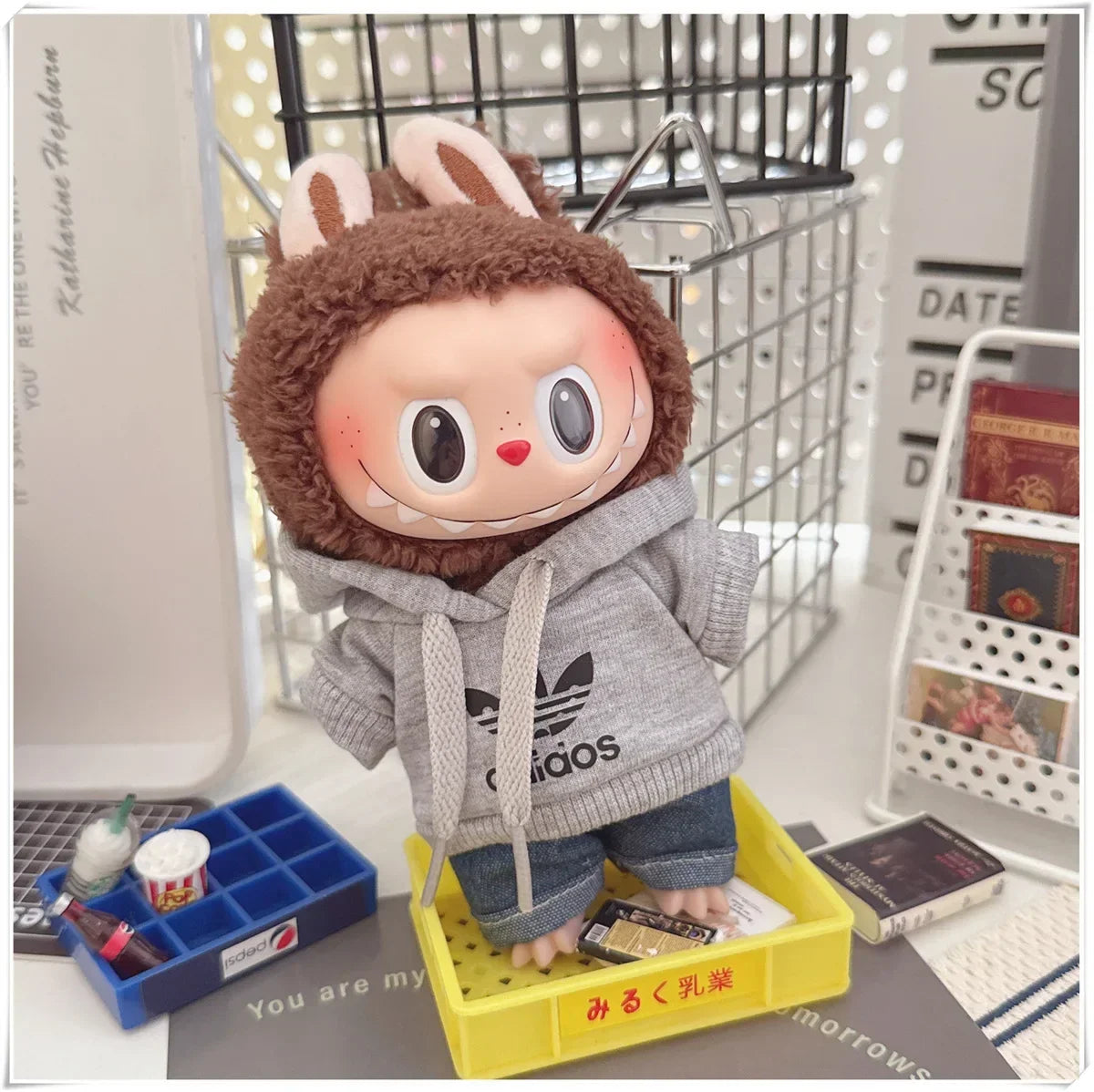 Plush toy with a hoodie and animal ears on a desk