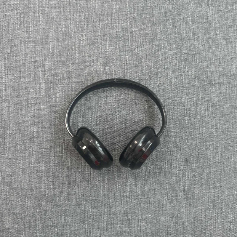 Black headphones on a gray textured fabric background