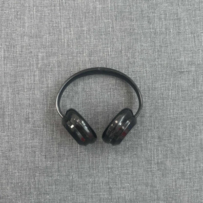 Black headphones on a gray textured fabric background
