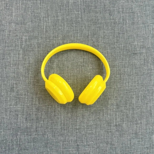Yellow earplugs on a gray textured background