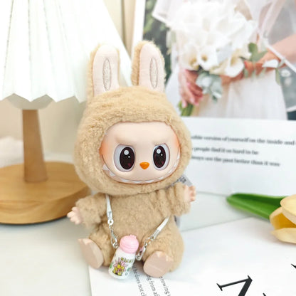 Plush toy with rabbit ears and a small backpack on a surface with blurred background