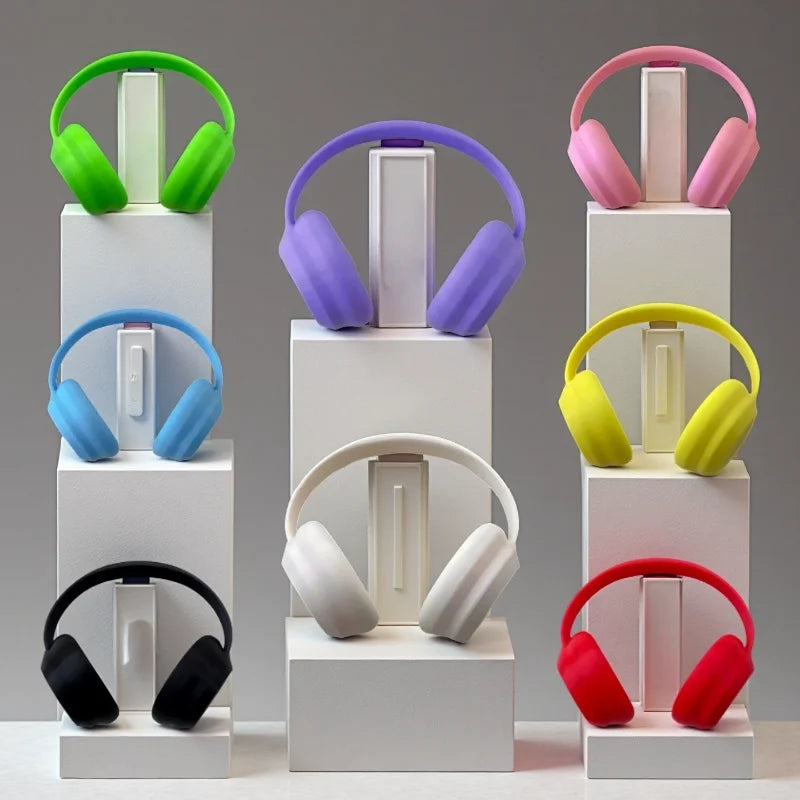 Colorful headphones on white stands against a gray background