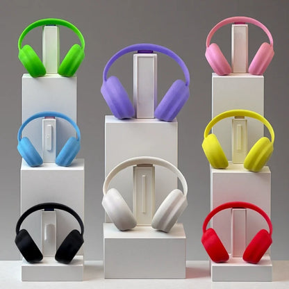 Colorful headphones on white stands against a gray background