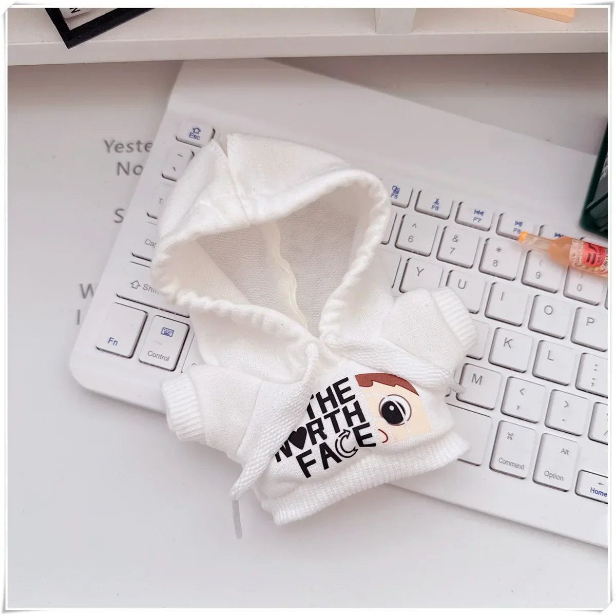 White knit hood with cartoon face design on a keyboard