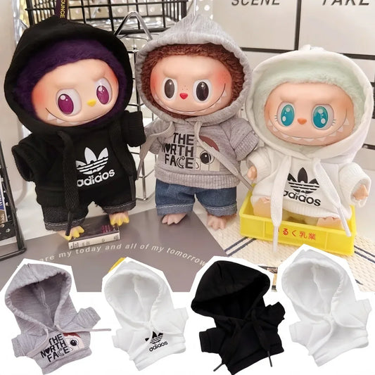 Three cartoon characters wearing hoodies with visible brand logos on a surface.
