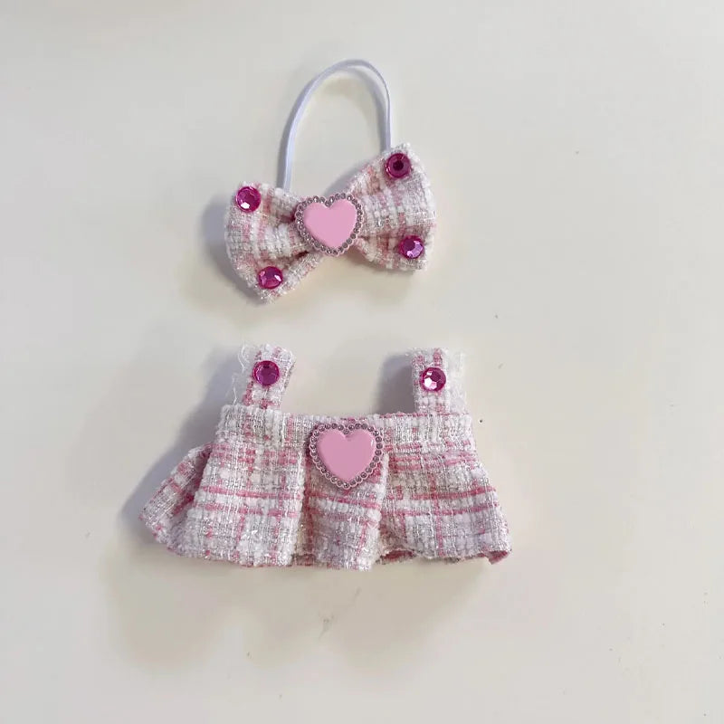 Small pink and white textured dress with a matching headband on a light beige background