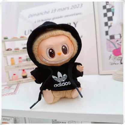 Plush toy with a black hoodie featuring Adidas logo on a white surface.