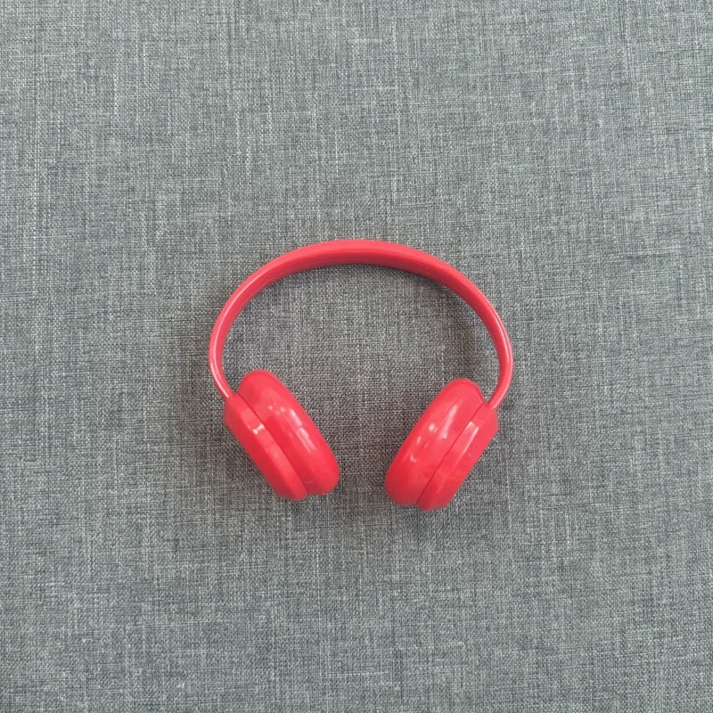 Red headphones on a gray textured background