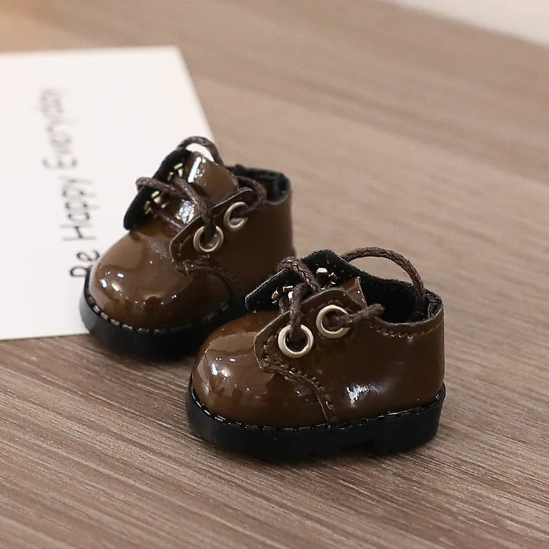 Pair of small brown shoes on a wooden surface