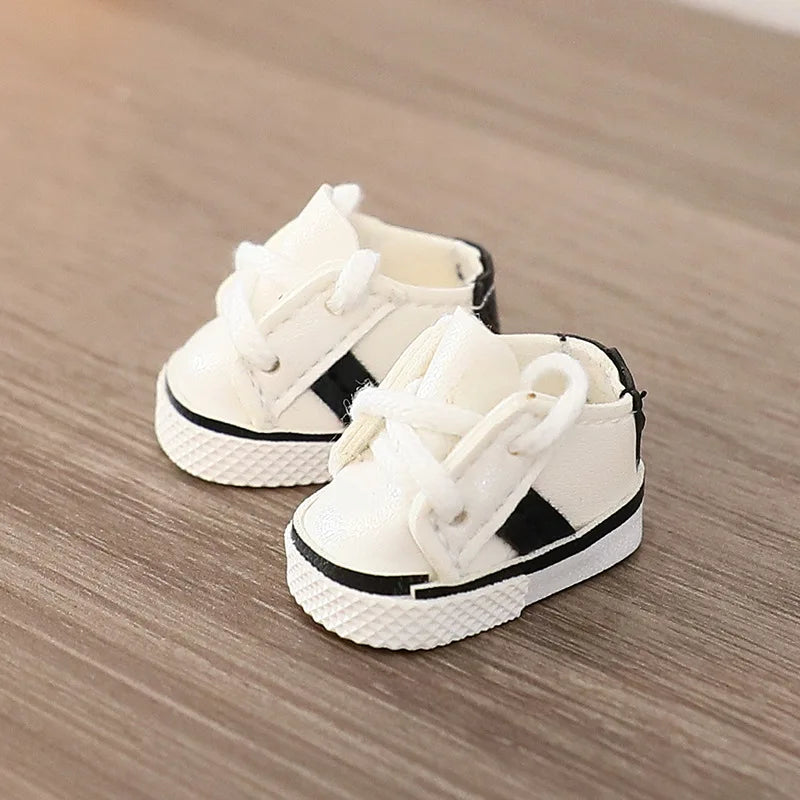 White high-top sneakers with black stripes on a wooden surface