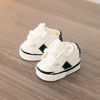 White high-top sneakers with black stripes on a wooden surface